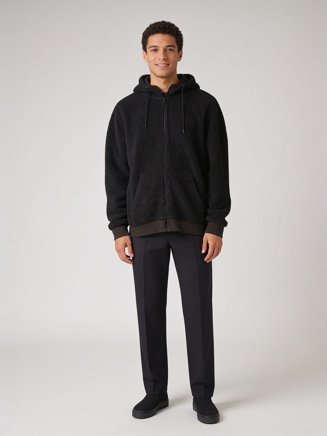 Model in a black sherpa fleece jacket